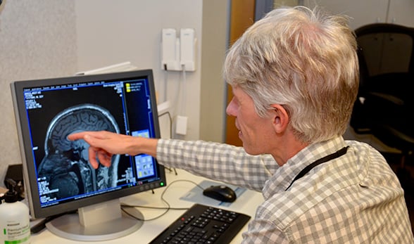 Joseph Schacht, PhD, studies brain scans of volunteers as part of his research to better understand alcohol-use disorder.
