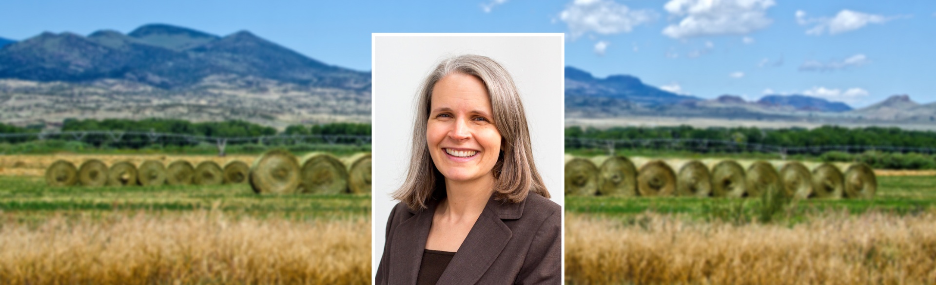 Woman smiling in headshot on background of Colorado mountains