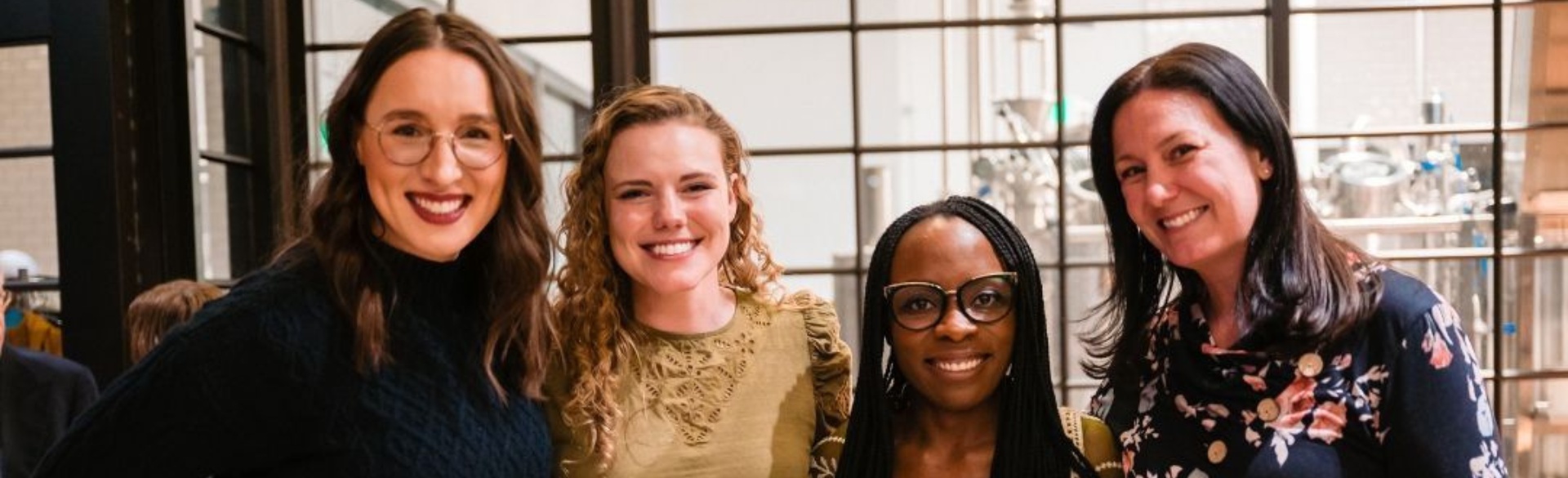 Four women smiling in photo together