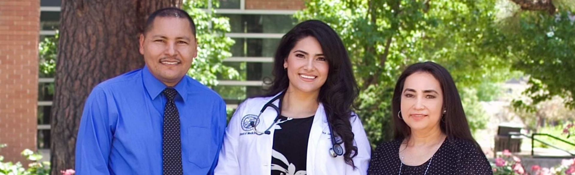 Jasmin Torres and her parents pose together at their own White Coat Ceremony at the CU Anschutz Medical Campus.