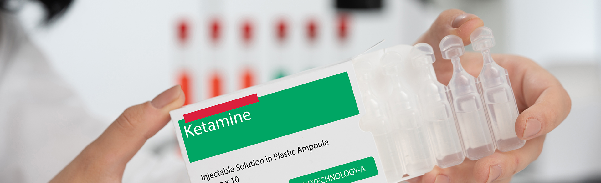 Gloved hand holding box of ketamine injectable doses