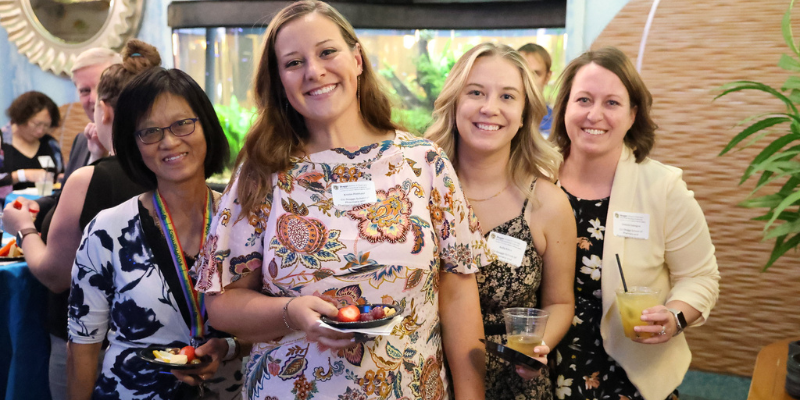 Four women pharmacists gather to celebrate their work in the field.